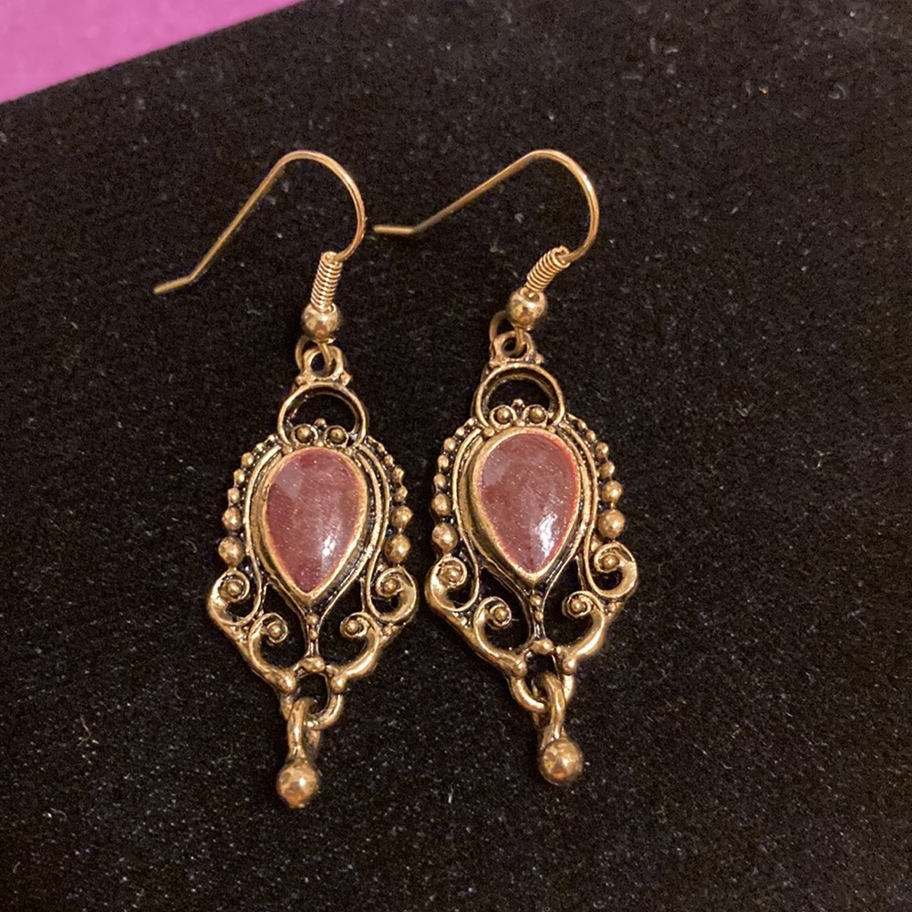 Antique gold tone ornate earrings with enameled teardrop center